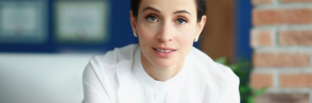 Portrait of young brunette woman in office