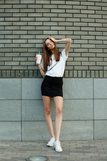 Photo portrait of a young brunette woman in a white tshirt