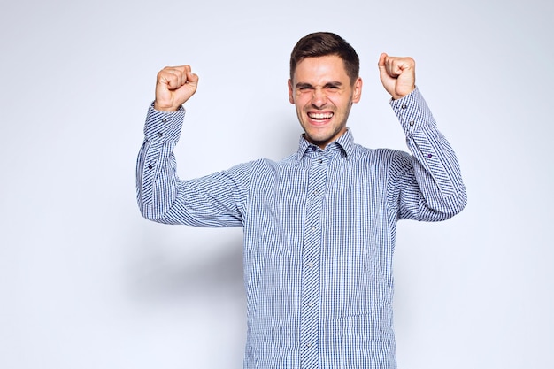 Portrait of young business man posing on gray background