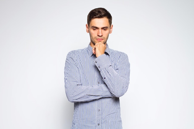 Portrait of young business man posing on gray background