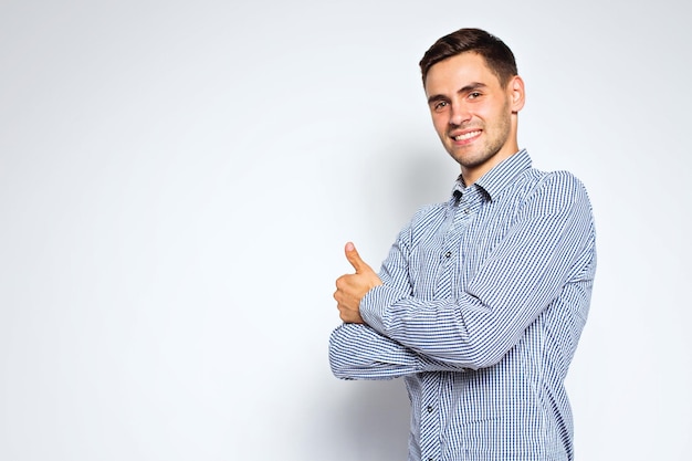 portrait of young business man posing on gray background