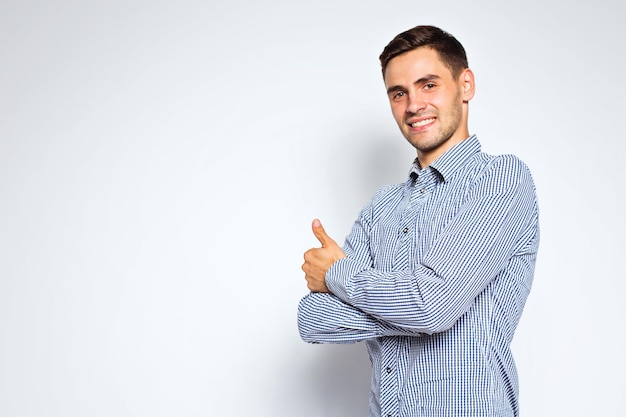 Portrait of young business man posing on gray background