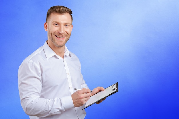 Portrait of young business man taking notes