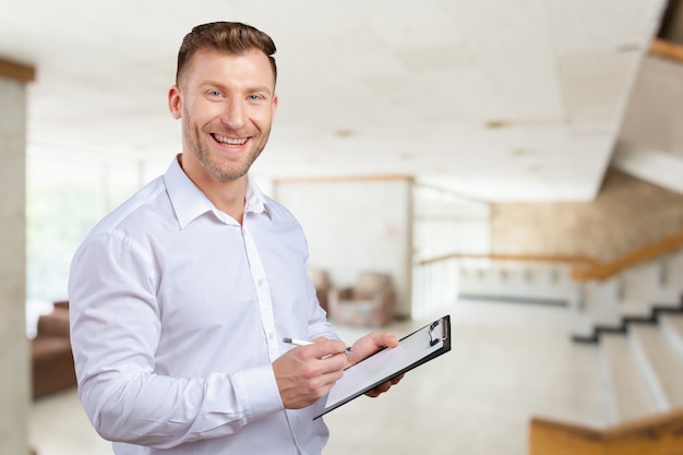 Portrait of young business man taking notes