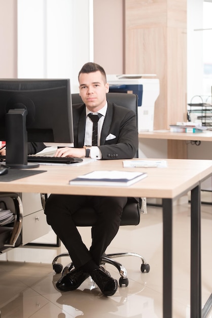 Portrait Of A Young Business Man Using A Computer In The Office