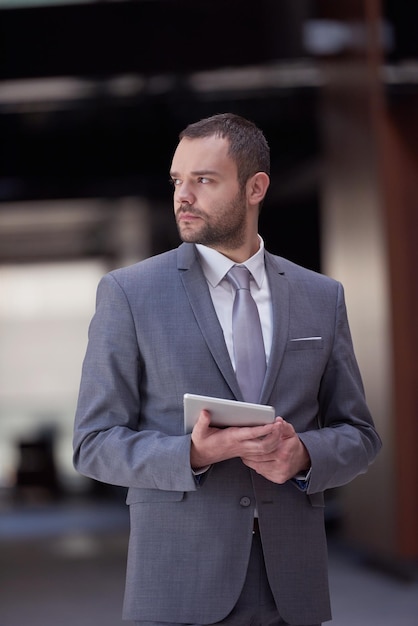 portrait of young business man with tablet computer at modern office