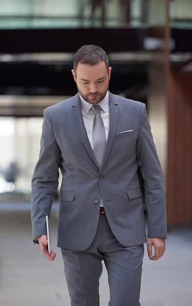 portrait of young business man with tablet computer at modern office