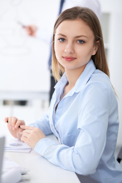 Portrait of a young business woman  at meeting.