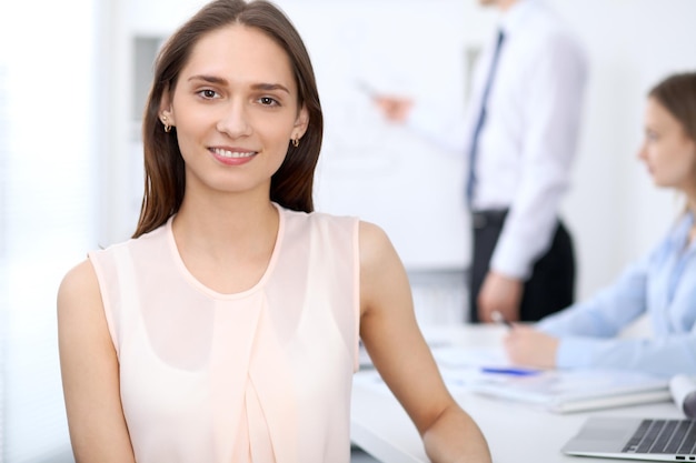 Portrait of a young business woman  at meeting.