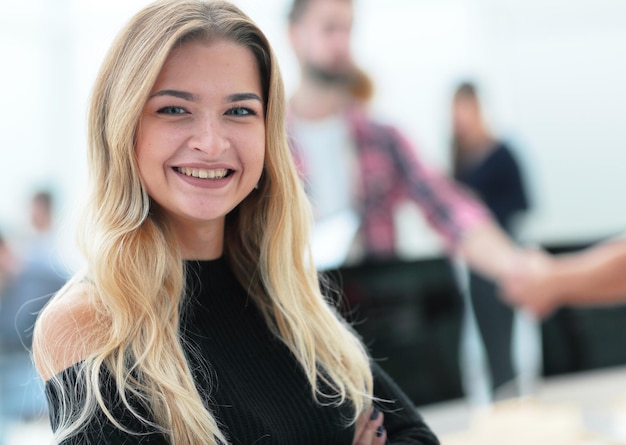 Portrait of a young business woman on an office background