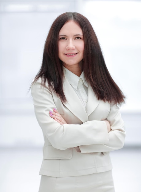 Portrait of young business woman on office window background