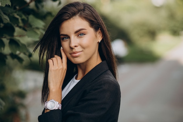 Portrait of young business woman in park