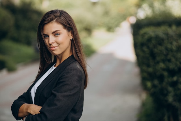 Portrait of young business woman in park