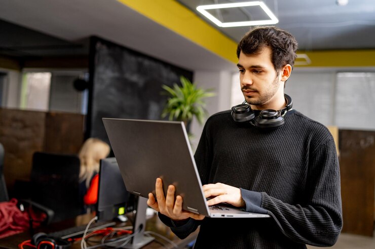 Photo portrait of young businessman in casual clothes at modern startup business office space working on laptop computer