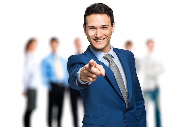 Portrait of young businessman pointing finger at viewer