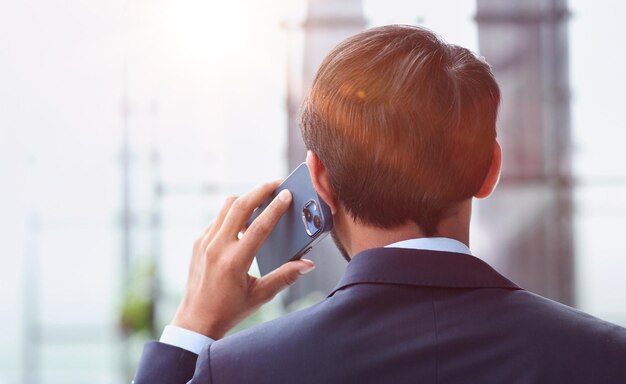 Portrait of a young businessman talking on the phone