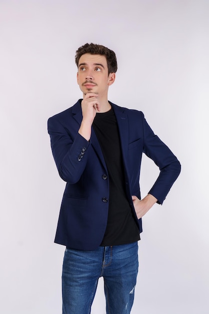 Portrait of young businessman thinking touching chin isolated over white background