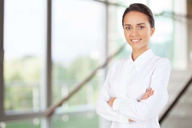 Portrait of young businesswoman on background