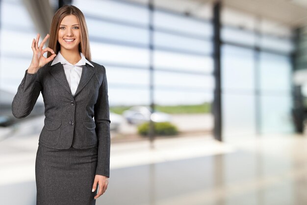 Portrait of a young businesswoman on background