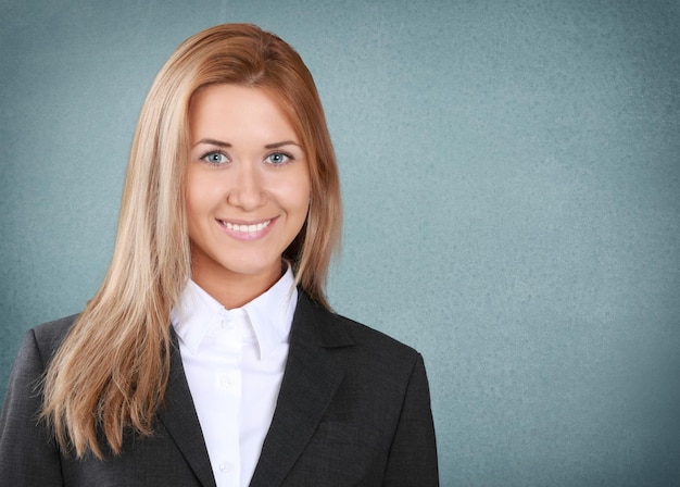 Portrait of young businesswoman on grey background