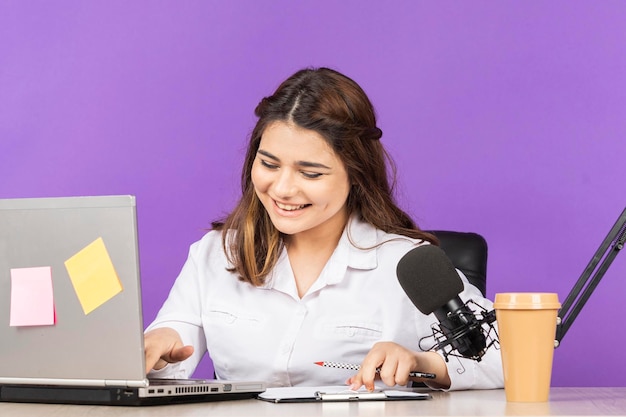 Portrait of young businesswoman sitting behind the desk and smiling High quality photo