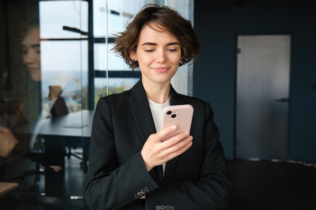 Portrait of young businesswoman using mobile phone