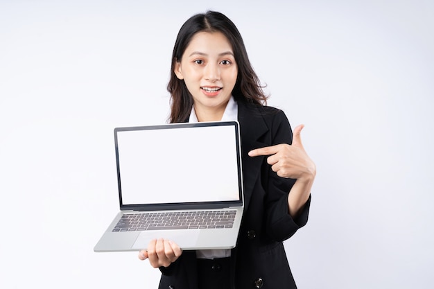 Portrait of young businesswoman wearing a suit, isolated on white background