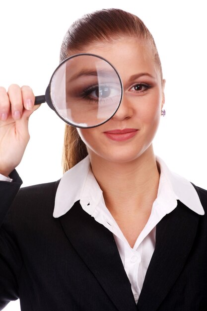 Portrait of young businesswoman with magnifying glass