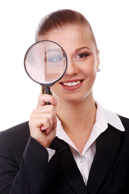 Portrait of young businesswoman with magnifying glass