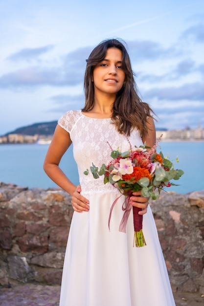 Portrait of young caucasian girl in a white wedding dress