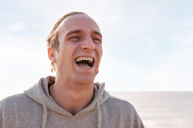 Portrait of a young caucasian man laughing happy