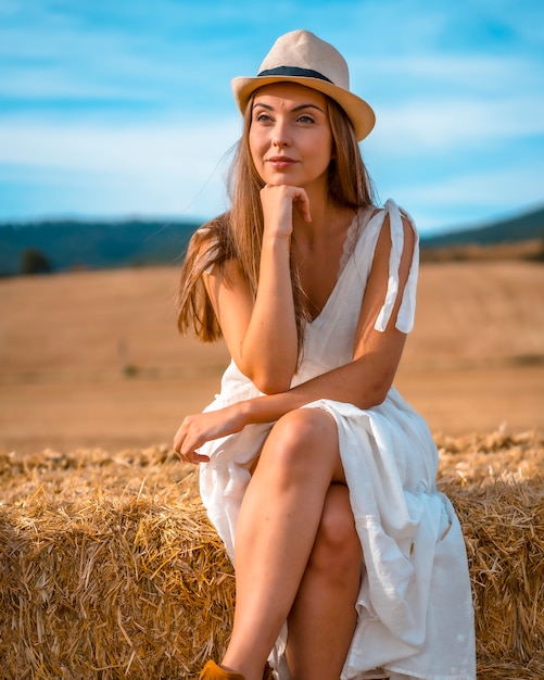 Portrait of a young Caucasian peasant girl in a dry field