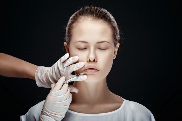 Portrait of young Caucasian woman getting cosmetic injection