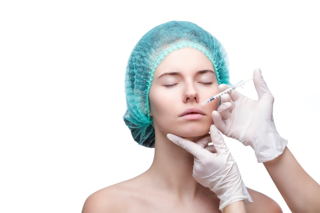 Portrait of young Caucasian woman getting cosmetic injection.