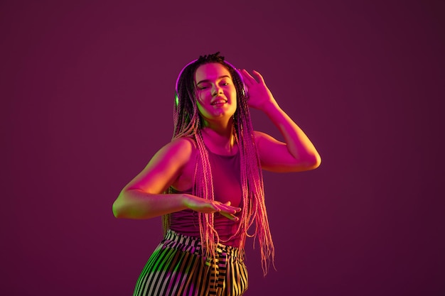 Portrait of young caucasian woman on pink background