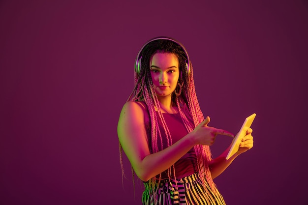 Portrait of young caucasian woman on pink background