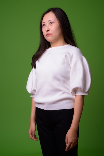 portrait of young Chinese woman on green