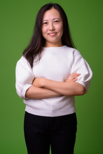 portrait of young Chinese woman on green