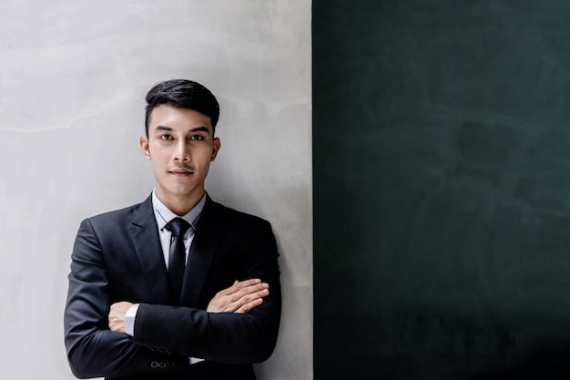 Portrait of Young Confident Businessman in Black Formal Suit.