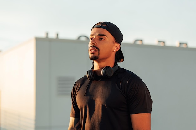 Portrait of a young confident male athlete in a cap