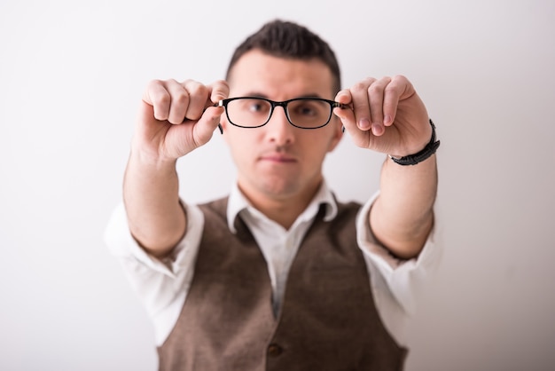 Portrait of young confident man with glasses.