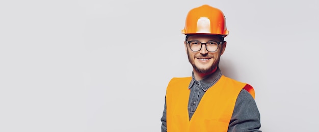 Portrait of young construction worker on white Panoramic banner copy space