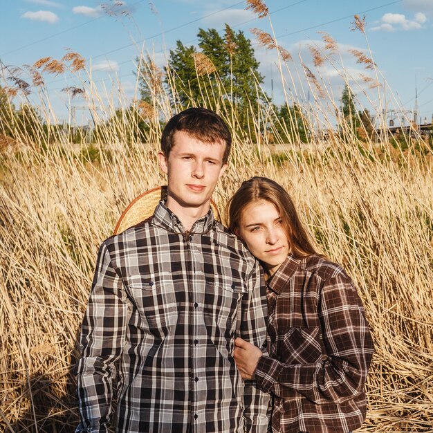 Portrait of young couple on field