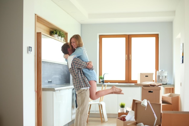 Portrait of young couple moving in new home Young couple