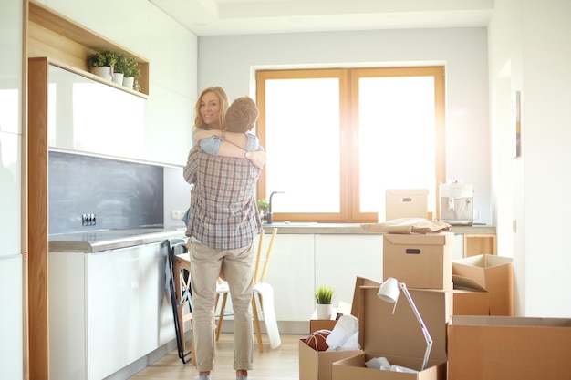 Portrait of young couple moving in new home Young couple
