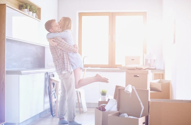 Portrait of young couple moving in new home. Young couple.