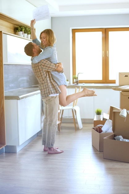 Portrait of young couple moving in new home Young couple