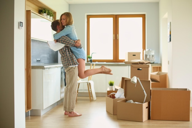 Portrait of young couple moving in new home. Young couple.