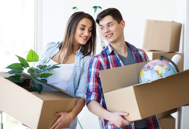 Portrait of young couple moving in new home