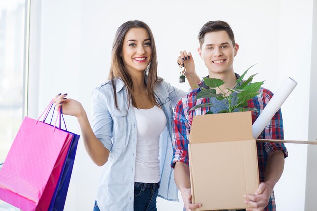 Portrait of young couple moving in new home